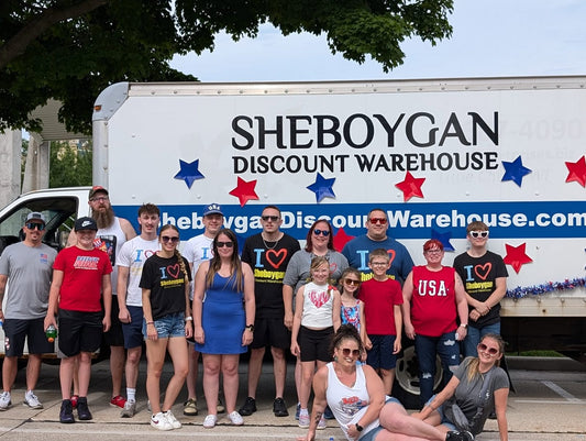 The Sheboygan Discount Warehouse team in front of the parade truck on the 4th of July
