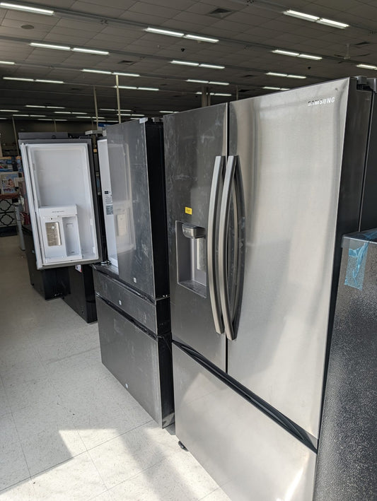 Scratch and dent Samsung french-door refrigerator on the floor at Sheboygan Discount Warehouse