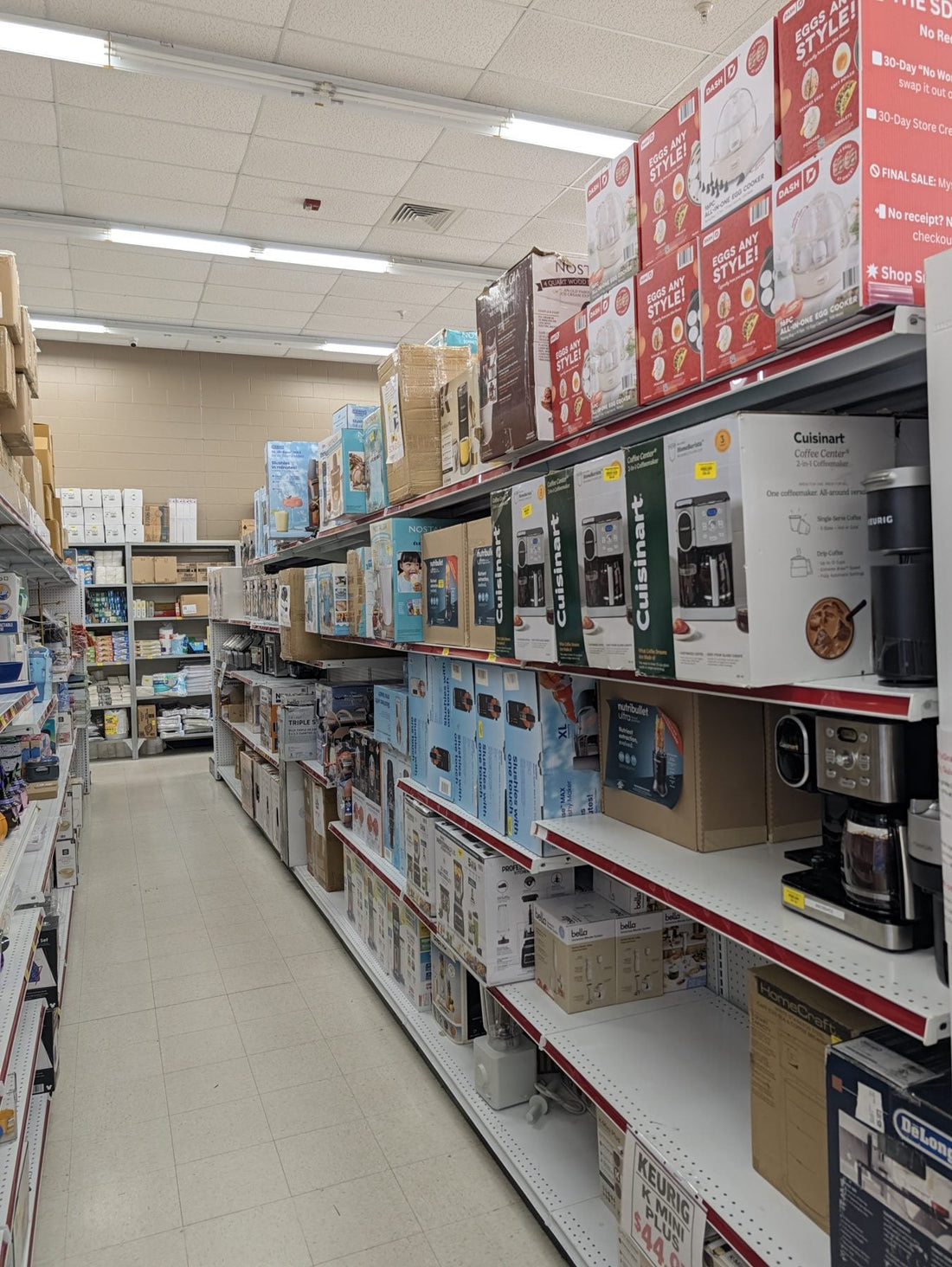 Kitchen aisle at Sheboygan Discount Warehouse stocked with overstock cookware and small appliances