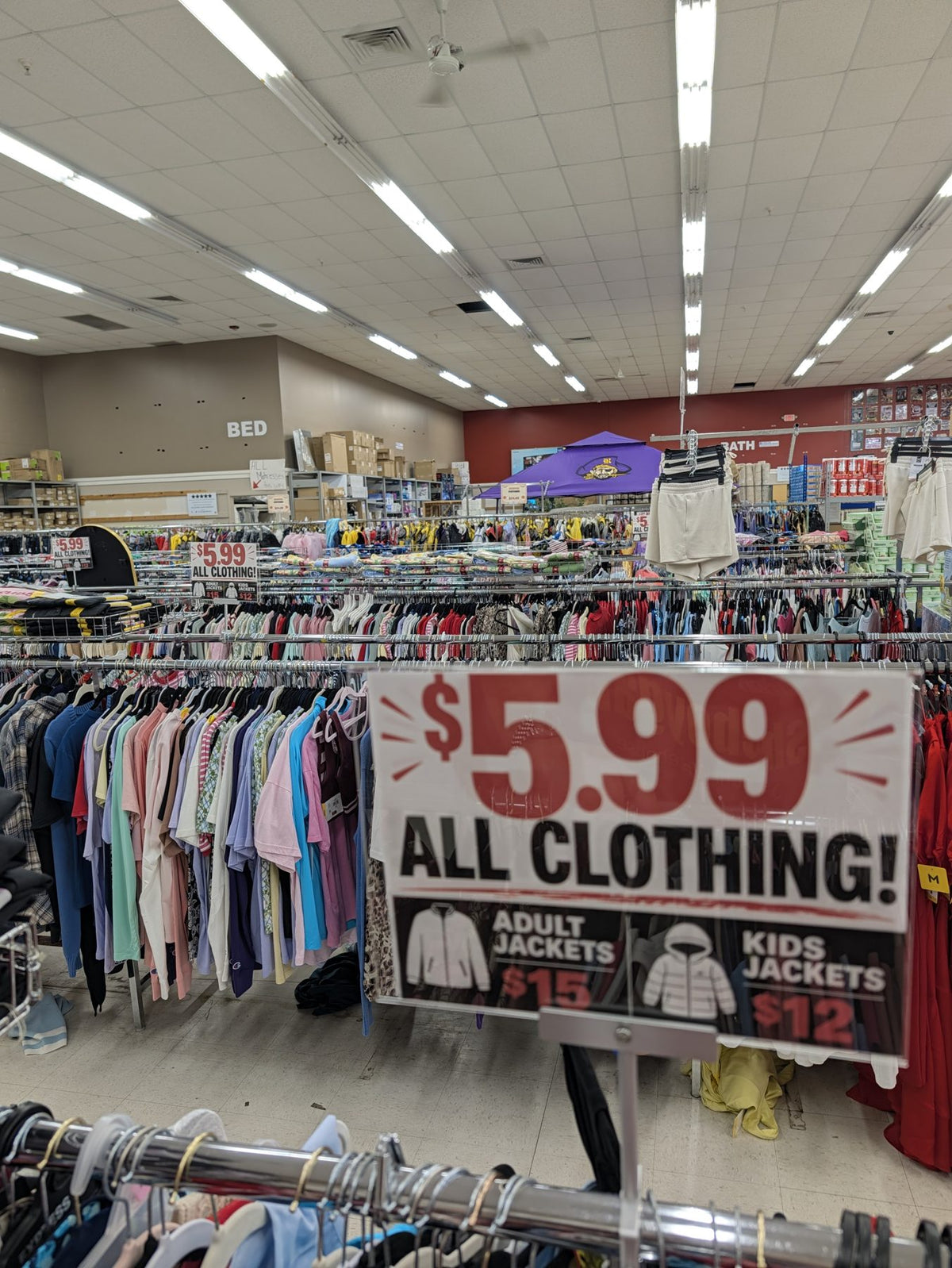 $5.99 All Clothing sign in front of racks of brand-new clothing at Sheboygan Discount Warehouse