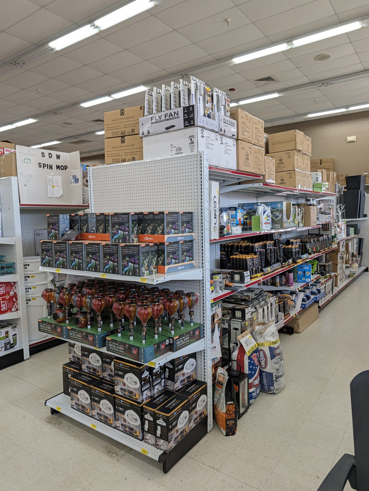 Endcap of solar landscape lights, ceiling lights and outdoor gear at Sheboygan Discount Warehouse